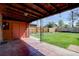 Covered patio overlooks a large, lush backyard with a privacy fence, and mature landscaping at 782 Holly St, Denver, CO 80220