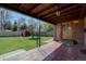 Covered patio overlooking a large yard with a red shed and mature trees at 782 Holly St, Denver, CO 80220