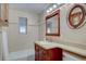 Bathroom featuring custom vanity with granite countertop, decorative mirrors, and tile backsplash at 782 Holly St, Denver, CO 80220