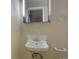 Pedestal sink in bathroom with mirrored medicine cabinet and towel bar at 782 Holly St, Denver, CO 80220