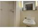 Bright bathroom with retro sink and faucet offers a shower stall and neutral tile at 782 Holly St, Denver, CO 80220