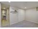 Bedroom with carpet and closet provides access to an adjacent tiled room with floating shelves at 782 Holly St, Denver, CO 80220