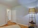 Bright bedroom features beautiful wood floors, a storage closet and stylish, modern lamp at 782 Holly St, Denver, CO 80220