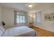 Serene bedroom with hardwood floors, natural light, and neutral decor at 782 Holly St, Denver, CO 80220
