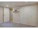 Bedroom featuring plush carpeting, white trim, and a four-door closet for ample storage at 782 Holly St, Denver, CO 80220