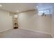 Spare bedroom offers a modern floor lamp, neutral walls and carpet and a window for natural light at 782 Holly St, Denver, CO 80220