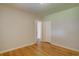 Bedroom with hardwood floors, white walls and view to another room with a closet at 782 Holly St, Denver, CO 80220