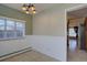 Bright dining area features wainscoting, chandelier and views to another room at 782 Holly St, Denver, CO 80220