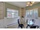 Cozy dining room featuring built-in shelving, wainscoting, and natural light from two windows at 782 Holly St, Denver, CO 80220