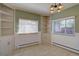 Cozy dining room featuring built-in shelving, wainscoting, and natural light from two windows at 782 Holly St, Denver, CO 80220