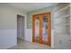 Inviting entryway with French doors, built-in shelving, and wainscoting at 782 Holly St, Denver, CO 80220