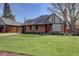 Charming brick home featuring a well-manicured lawn and a pop of color from the red front door at 782 Holly St, Denver, CO 80220
