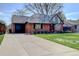 Charming brick home with attached garage and well-manicured lawn at 782 Holly St, Denver, CO 80220