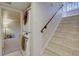 Basement area with tiled steps and side-by-side laundry machines near bedroom entrance at 782 Holly St, Denver, CO 80220