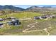 Panoramic aerial shot showcasing the property's expansive grounds and surrounding scenic landscape at 15191 Dinosaur Ridge Rd, Morrison, CO 80465