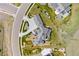 Aerial view of a luxurious home showing the unique roofline, landscaping and circular driveway at 15191 Dinosaur Ridge Rd, Morrison, CO 80465