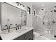 Modern bathroom with marble and glass shower, sleek black hardware, and contemporary lighting at 15191 Dinosaur Ridge Rd, Morrison, CO 80465