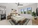 Bright bedroom with an ensuite bath, ceiling fan, a bench at the end of the bed and three windows with a view at 15191 Dinosaur Ridge Rd, Morrison, CO 80465