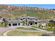 Beautiful exterior of a modern home with a three-car garage, set against a scenic mountain backdrop at 15191 Dinosaur Ridge Rd, Morrison, CO 80465