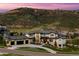 Stunning exterior elevation of a modern home, featuring a three-car garage and mountain views at 15191 Dinosaur Ridge Rd, Morrison, CO 80465