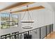 Foyer boasts soaring ceilings, contemporary chandeliers and plentiful natural light from large windows at 15191 Dinosaur Ridge Rd, Morrison, CO 80465
