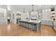 Open-concept kitchen with a large island, stainless steel appliances, and hardwood floors at 15191 Dinosaur Ridge Rd, Morrison, CO 80465