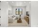 Inviting living room boasts natural light, comfortable seating, stylish furnishings, and calming natural color palette at 15191 Dinosaur Ridge Rd, Morrison, CO 80465