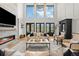 Bright, modern living room with soaring ceilings, fireplace and stylish furnishings at 15191 Dinosaur Ridge Rd, Morrison, CO 80465