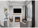 Cozy living room with a modern fireplace, comfortable seating, and elegant decor at 15191 Dinosaur Ridge Rd, Morrison, CO 80465