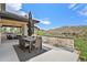 Outdoor dining area with built-in barbecue and beautiful views of the Colorado landscape during the day at 15191 Dinosaur Ridge Rd, Morrison, CO 80465