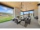 Relaxing outdoor living area with a stone fireplace, wooden ceiling, comfortable seating and views at 15191 Dinosaur Ridge Rd, Morrison, CO 80465