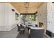 Inviting outdoor living area featuring a fireplace, built-in grill, wooden ceiling, and comfortable seating at 15191 Dinosaur Ridge Rd, Morrison, CO 80465