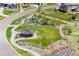 Aerial shot of a community park featuring a playground, covered picnic area, and walking trails at 15191 Dinosaur Ridge Rd, Morrison, CO 80465