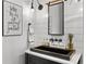 Chic powder room with a unique black sink, modern fixtures, and decorative shiplap walls at 15191 Dinosaur Ridge Rd, Morrison, CO 80465