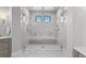 Expansive shower with marble surround, dual shower heads, bench seating, and glass enclosure at 15191 Dinosaur Ridge Rd, Morrison, CO 80465