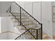 Staircase featuring wooden steps, black iron railing, and contemporary design at 15191 Dinosaur Ridge Rd, Morrison, CO 80465