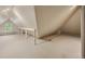Bright attic space featuring natural light from a large window and unique architectural details at 5530 E 6Th Ave Pkwy, Denver, CO 80220