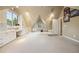 Well-lit attic with built-in shelving and desks, offering a versatile workspace and storage solutions at 5530 E 6Th Ave Pkwy, Denver, CO 80220