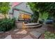 Charming patio with an inviting seating area, surrounded by lush greenery and stone pathways at 5530 E 6Th Ave Pkwy, Denver, CO 80220