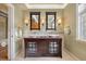 Bathroom featuring double sinks, a wood vanity, and unique lighting at 5530 E 6Th Ave Pkwy, Denver, CO 80220