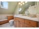 Bright bathroom with modern fixtures, a skylight, and a vanity with ample counter space at 5530 E 6Th Ave Pkwy, Denver, CO 80220