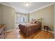 Comfortable bedroom featuring hardwood floors, a window seat, and a relaxing ambiance at 5530 E 6Th Ave Pkwy, Denver, CO 80220