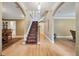 Spacious foyer featuring hardwood floors, elegant staircase, and arched doorways at 5530 E 6Th Ave Pkwy, Denver, CO 80220
