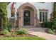 Inviting front entrance with brick archway, decorative iron gate, and well-maintained garden at 5530 E 6Th Ave Pkwy, Denver, CO 80220