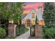 Charming Tudor-style home with stone walkway, manicured lawn, and mature landscaping at dusk at 5530 E 6Th Ave Pkwy, Denver, CO 80220