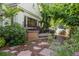 Charming front porch with brick accents and lush landscaping offering a welcoming entrance to the home at 5530 E 6Th Ave Pkwy, Denver, CO 80220