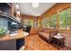 Spacious home office with custom built-ins, ample natural light, and a comfortable seating area at 5530 E 6Th Ave Pkwy, Denver, CO 80220