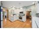 Well-equipped kitchen with white cabinets, modern appliances, and convenient access to the dining area at 5530 E 6Th Ave Pkwy, Denver, CO 80220