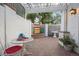 Enclosed patio area with water feature, brick flooring, and a decorative privacy screen perfect for entertaining at 5530 E 6Th Ave Pkwy, Denver, CO 80220