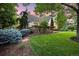 Spacious yard with lush green grass, mature trees, and well-maintained landscaping at 5530 E 6Th Ave Pkwy, Denver, CO 80220